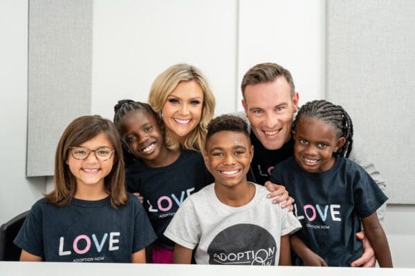 A group of people wearing black shirts and smiling.