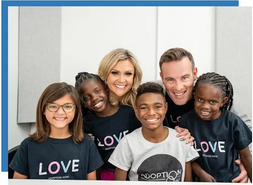 A group of people wearing black shirts and smiling.