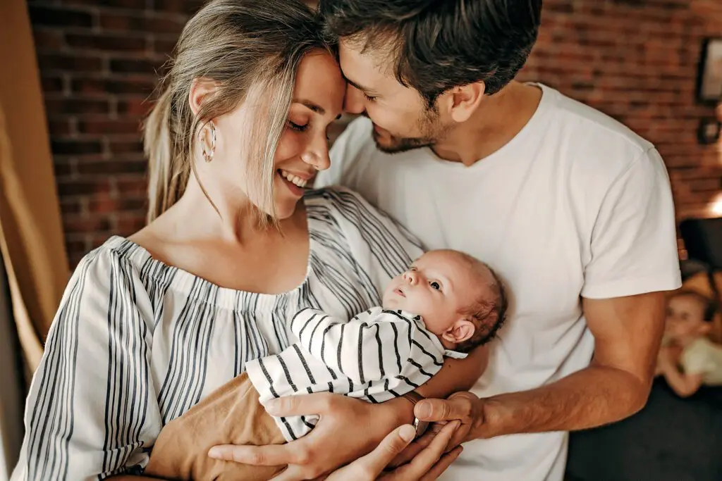 A man and woman holding a baby in their arms.