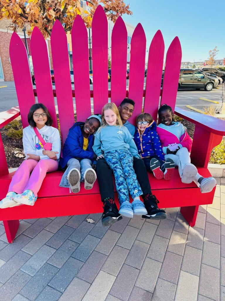 kids sitting outside in chair